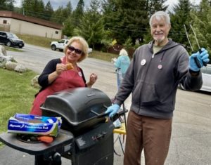 2024 Cook Ski and Marlys serving hot dogs.