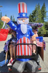 Judi and Margaret enjoy the ride with Uncle Sam at Bayview Daze Parade 2024