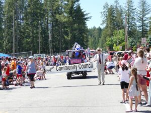 Sue and John proudly dispaly the Bayview Community Council's banner during the Bayview Daze Parade 2024