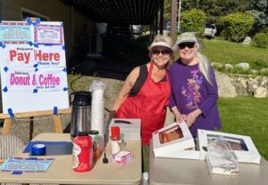 Marlys and Laurie looking pretty selling donuts and coffee 2025.